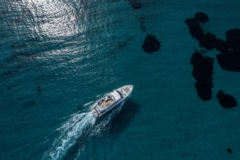  Yacht Photos Pics Aerial view of 2020 Princess F70 yacht cruising on clear blue water.