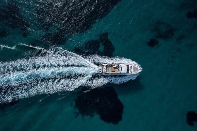  Yacht Photos Pics Aerial view of 2020 Princess F70 yacht cruising on clear blue water.
