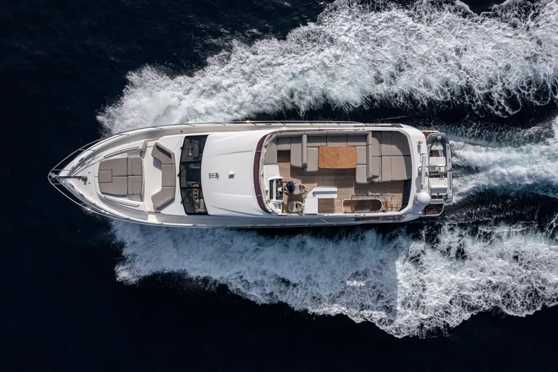  Yacht Photos Pics Aerial view of 2020 Princess F70 yacht cruising on open water.