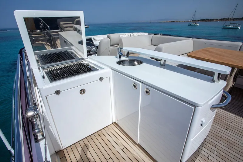  Yacht Photos Pics Outdoor kitchen on 2020 Princess F70 yacht with grill and sink, overlooking blue ocean.