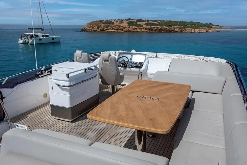  Yacht Photos Pics Luxurious 2020 Princess F70 yacht deck with seating, table, and ocean view.