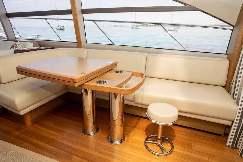  Yacht Photos Pics Luxurious interior of 2020 Princess F70 yacht with elegant seating and wooden table.