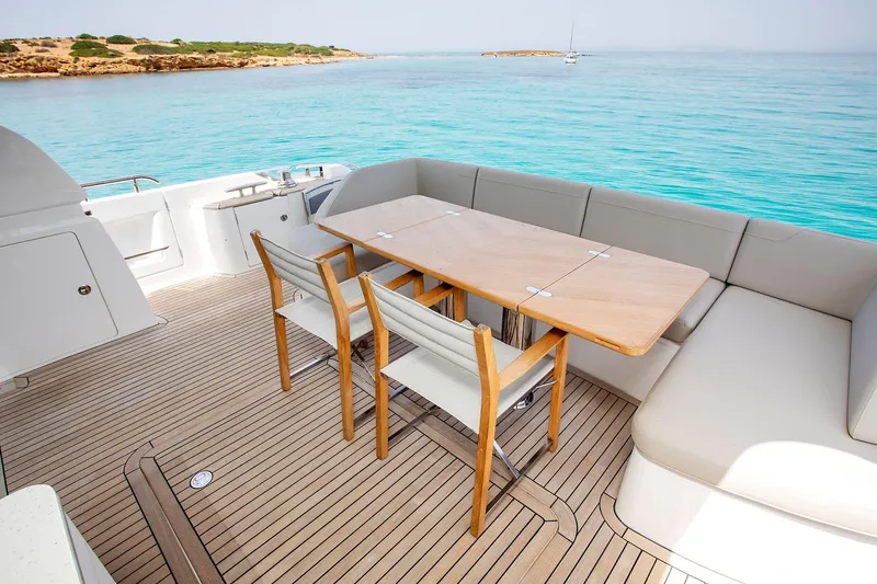  Yacht Photos Pics Luxury yacht deck with dining area, Princess F70, 2020 model, overlooking turquoise waters.