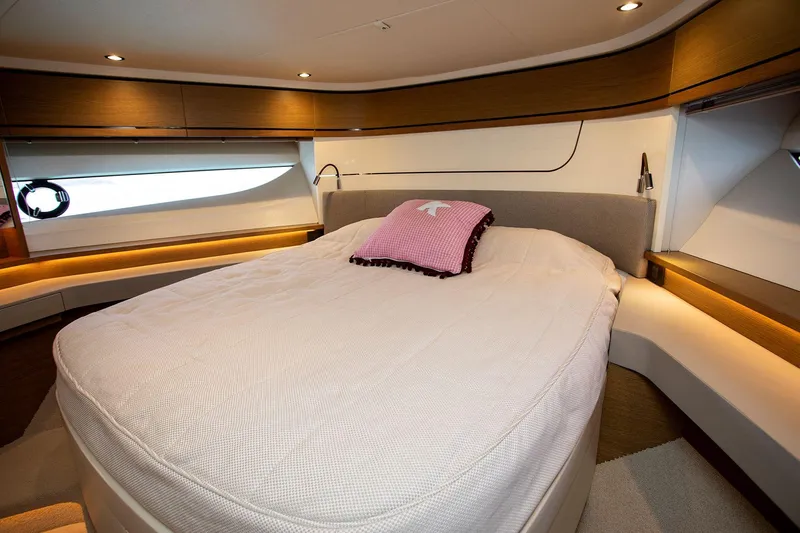  Yacht Photos Pics Luxurious bedroom interior of 2020 Princess F70 yacht with elegant bedding and ambient lighting.