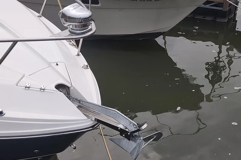  Yacht Photos Pics 2017 Rinker EX 320 boat with anchor, docked on calm water.