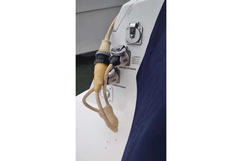  Yacht Photos Pics 2017 Rinker EX 320 boat shore power connection with cables and air conditioner label.