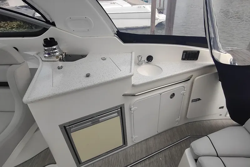  Yacht Photos Pics 2017 Rinker EX 320 boat interior with kitchenette and seating area.