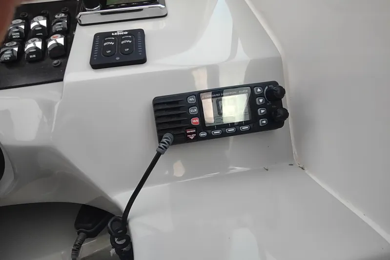  Yacht Photos Pics Control panel of a 2017 Rinker EX 320 boat with radio and switches.