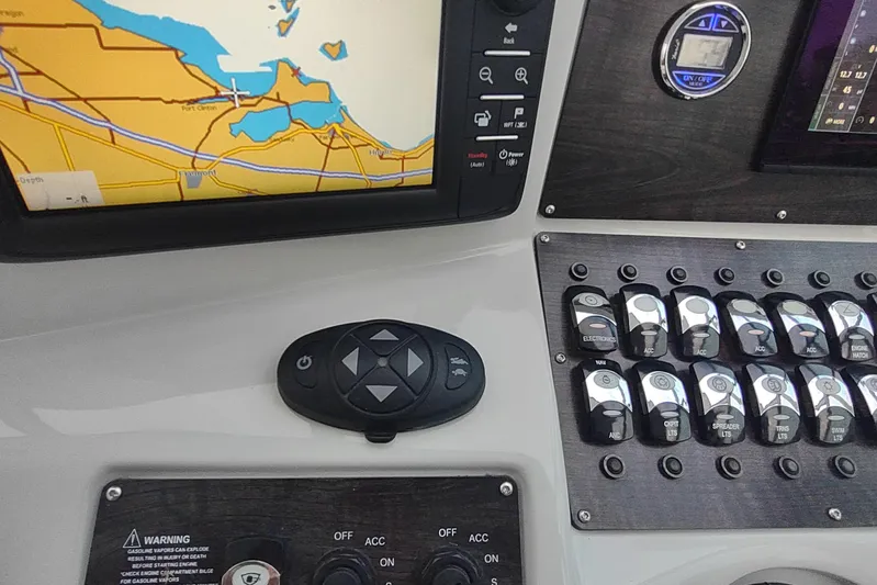  Yacht Photos Pics Control panel of a 2017 Rinker EX 320 boat with navigation display and switches.