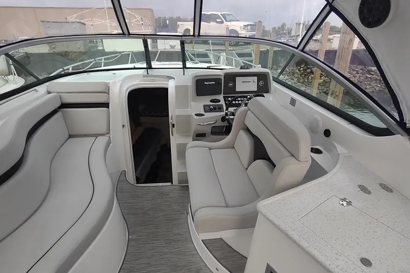  Yacht Photos Pics 2017 Rinker EX 320 boat interior with helm, seating, and cabin entrance.