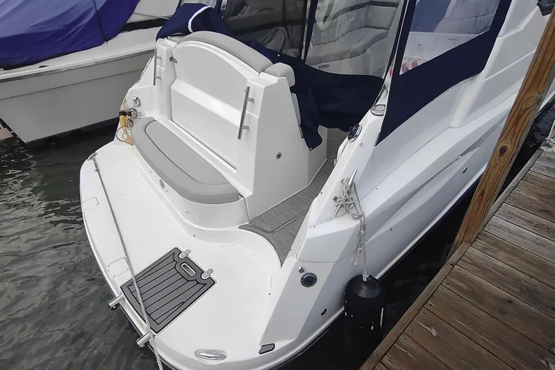  Yacht Photos Pics 2017 Rinker EX 320 boat docked, featuring a spacious rear deck and seating area.