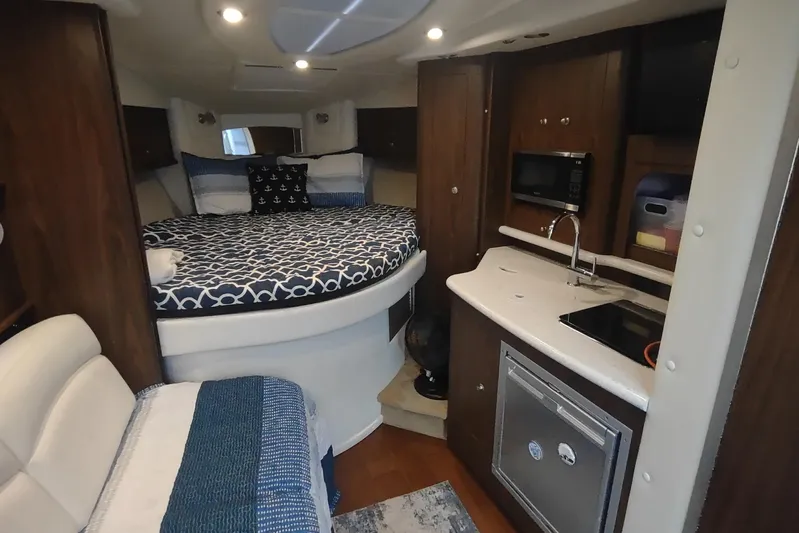  Yacht Photos Pics 2017 Rinker EX 320 cabin interior with bed, kitchenette, and seating area.