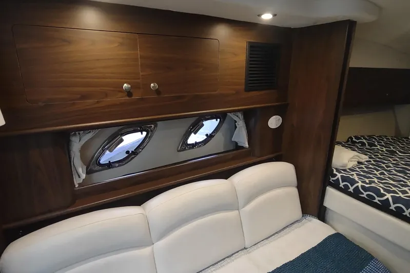  Yacht Photos Pics Interior of 2017 Rinker EX 320 yacht with wood cabinets and cozy seating area.