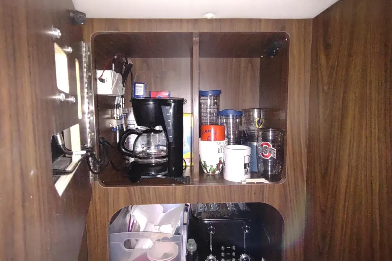  Yacht Photos Pics Cabinet interior with coffee maker and mugs on a 2017 Rinker EX 320 boat.