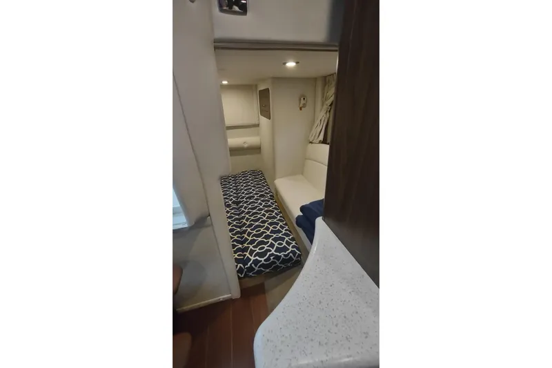  Yacht Photos Pics 2017 Rinker EX 320 cabin interior with patterned bedding and modern design.