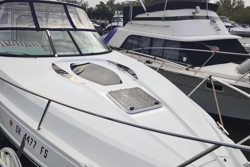  Yacht Photos Pics 2017 Rinker EX 320 boat docked at marina, featuring sleek design and spacious deck.