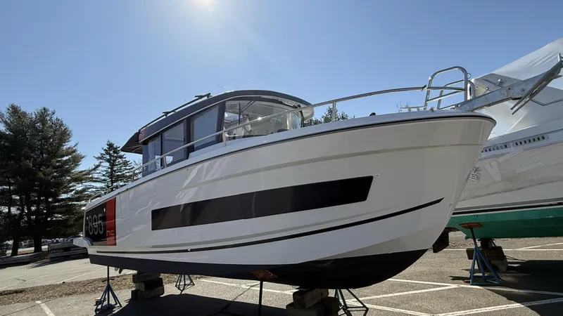 Scrimshaw III Yacht Photos Pics 2024 Jeanneau 895 Sport boat on display in a sunny outdoor setting.