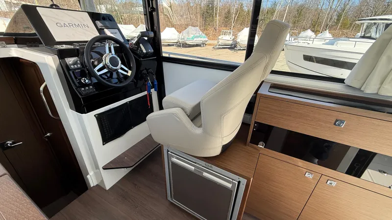 Scrimshaw III Yacht Photos Pics 2024 Jeanneau 895 Sport interior with helm, Garmin controls, and modern seating.