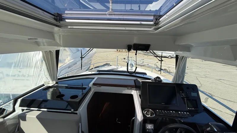 Scrimshaw III Yacht Photos Pics 2024 Jeanneau 895 Sport cockpit with modern navigation equipment and panoramic views.