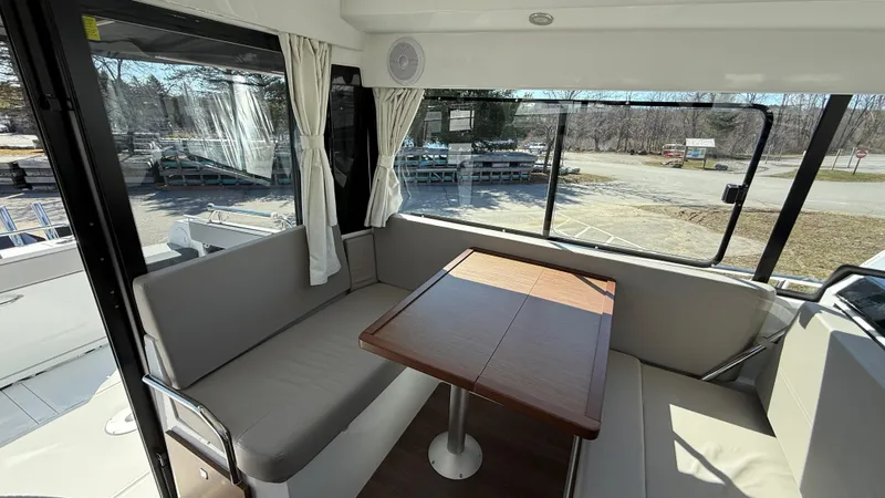 Scrimshaw III Yacht Photos Pics Interior of 2024 Jeanneau 895 Sport boat with seating and table.