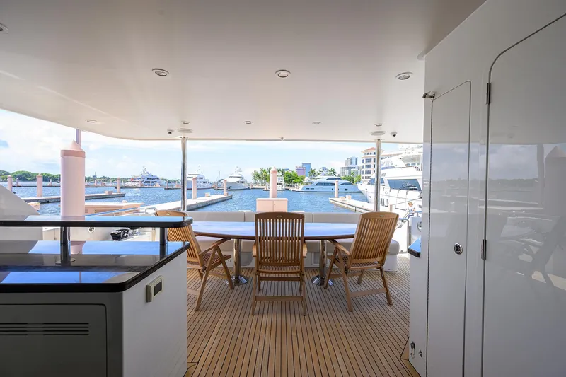 Claypen Yacht Photos Pics Luxurious 2013 Ocean Alexander Sky Lounge yacht deck with marina view and wooden seating.