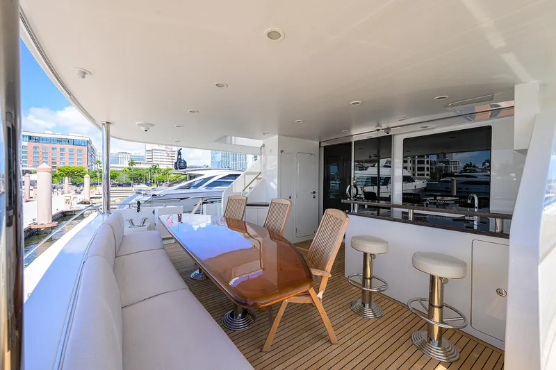 Claypen Yacht Photos Pics Luxurious 2013 Ocean Alexander Sky Lounge yacht deck with seating, table, and bar stools.