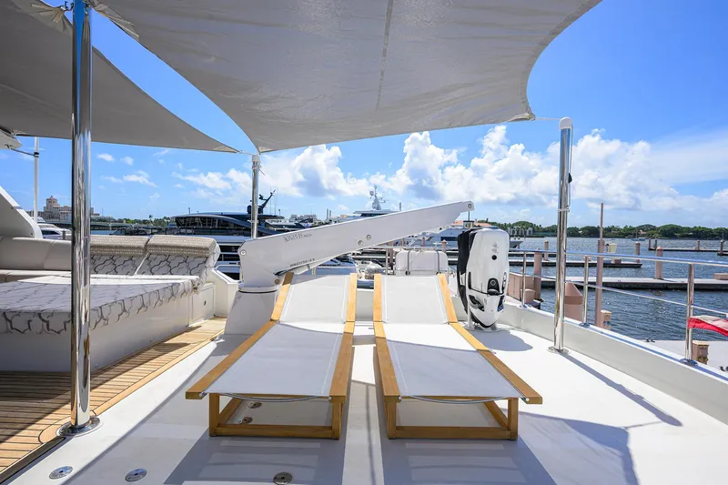 Claypen Yacht Photos Pics 2013 Ocean Alexander Sky Lounge yacht deck with sun loungers and marina view.
