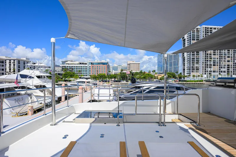 Claypen Yacht Photos Pics 2013 Ocean Alexander Sky Lounge yacht docked in a marina with cityscape background.