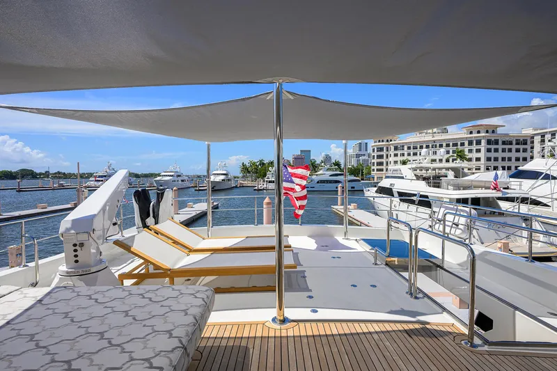 Claypen Yacht Photos Pics Luxurious 2013 Ocean Alexander Sky Lounge yacht docked at a marina with sun loungers.