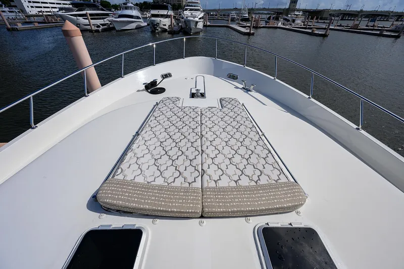 Claypen Yacht Photos Pics 2013 Ocean Alexander Sky Lounge yacht with patterned sunbathing cushions at marina.
