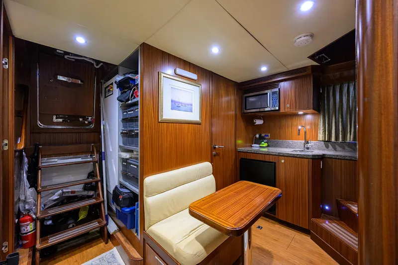 Claypen Yacht Photos Pics Luxurious 2013 Ocean Alexander Sky Lounge interior with kitchenette, seating, and storage.