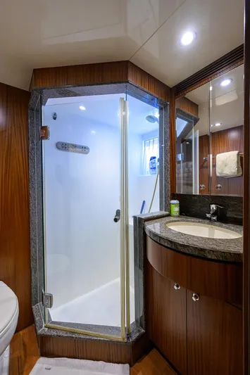 Claypen Yacht Photos Pics Luxurious bathroom in 2013 Ocean Alexander Sky Lounge yacht with glass shower and elegant wood finishes.