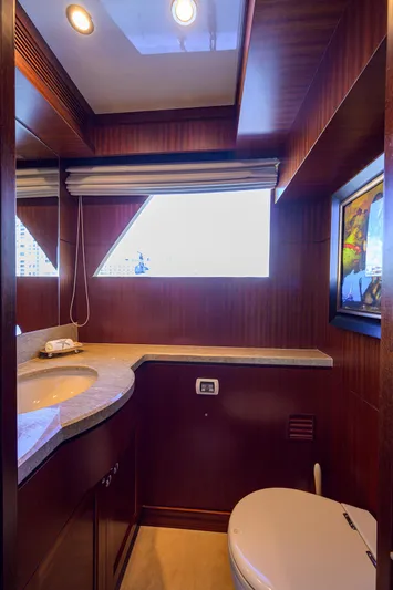 Claypen Yacht Photos Pics Luxurious bathroom in 2013 Ocean Alexander Sky Lounge yacht with modern fixtures and wood accents.