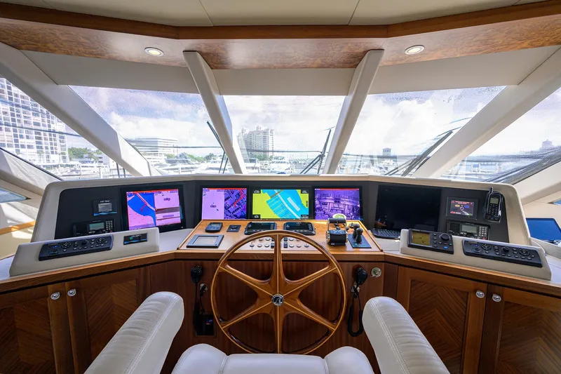 Claypen Yacht Photos Pics Helm of 2013 Ocean Alexander Sky Lounge yacht with navigation screens and wooden steering wheel.