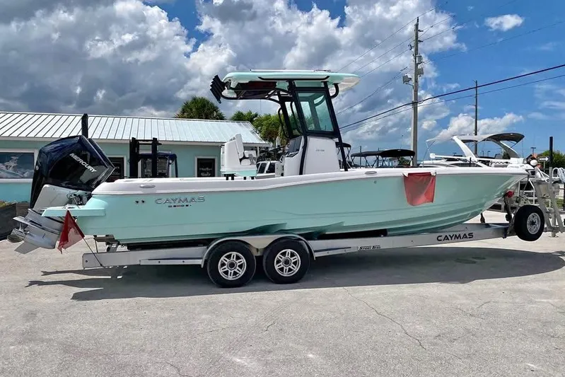  Yacht Photos Pics 2023 Caymas 281 HB boat on trailer, parked outdoors under cloudy sky.