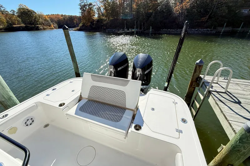  Yacht Photos Pics 2023 Caymas 281 HB boat with dual Mercury engines docked by a serene lake.