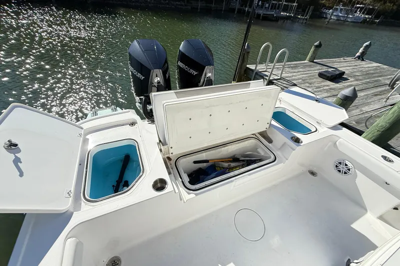  Yacht Photos Pics 2023 Caymas 281 HB boat with open storage compartments and dual Mercury engines.