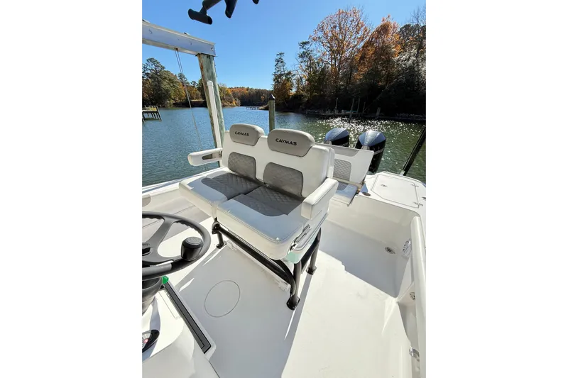  Yacht Photos Pics 2023 Caymas 281 HB boat interior with dual seats and scenic water view.