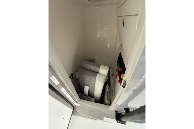  Yacht Photos Pics 2023 Caymas 281 HB interior storage with cushioned seating and control panel.