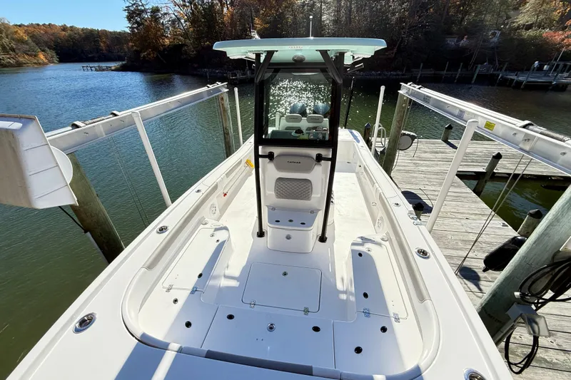  Yacht Photos Pics 2023 Caymas 281 HB boat docked on a scenic lake with autumn foliage.