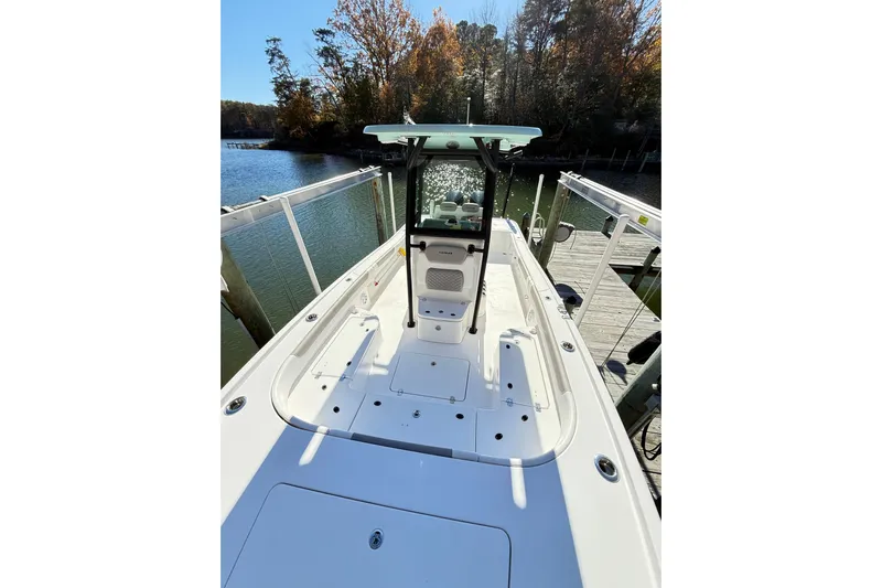  Yacht Photos Pics 2023 Caymas 281 HB boat docked by a scenic waterfront with autumn trees.