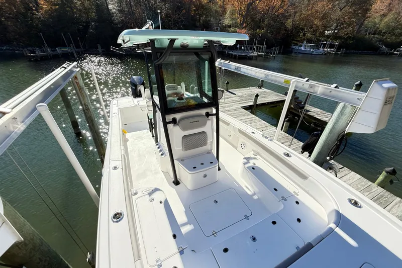  Yacht Photos Pics 2023 Caymas 281 HB boat docked on a sunny waterfront with sparkling water.