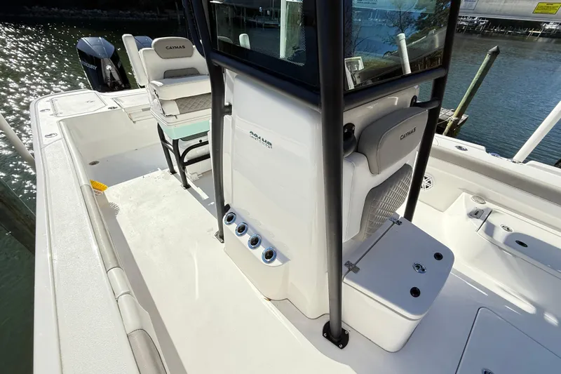  Yacht Photos Pics 2023 Caymas 281 HB boat interior with seating and storage, docked by the water.