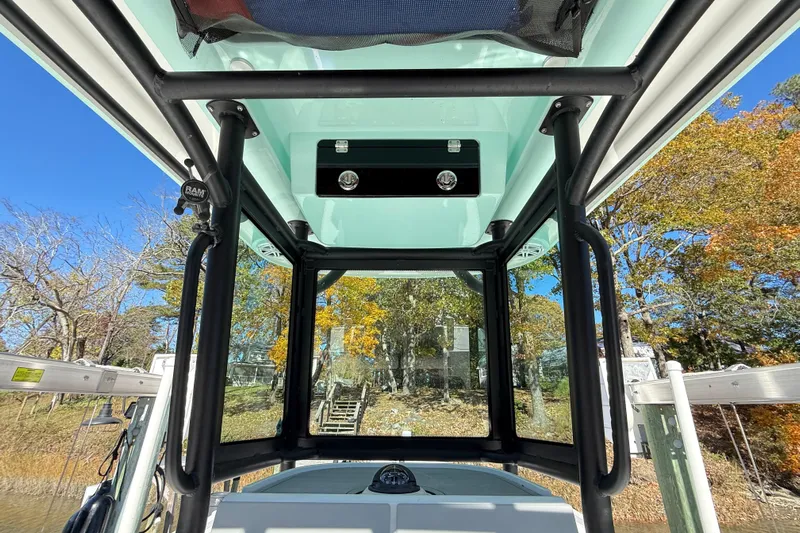  Yacht Photos Pics Interior view of 2023 Caymas 281 HB boat with clear canopy and scenic background.