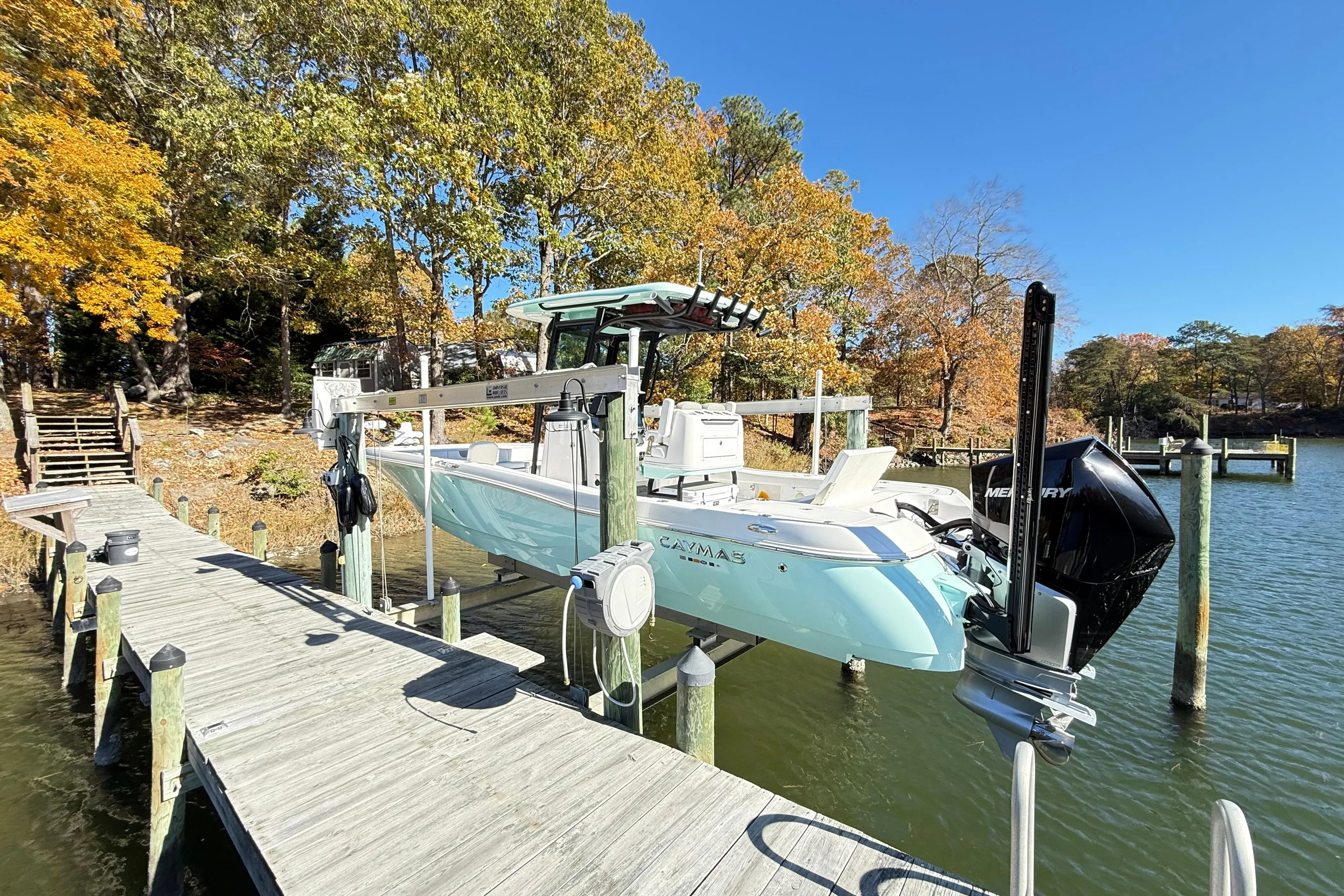 2023 Caymas 281 HB boat docked on a sunny autumn day by the lake.