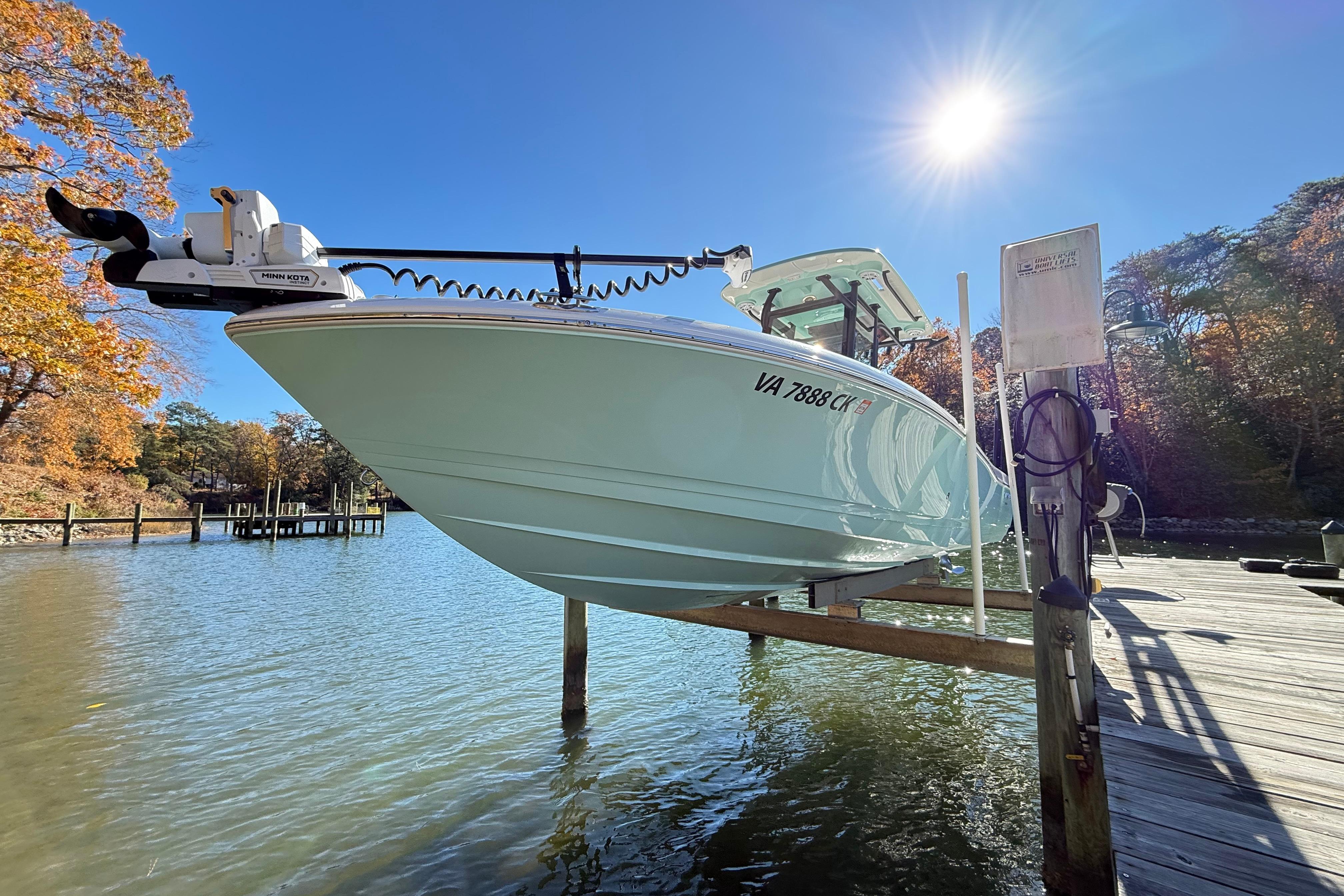 2023 Caymas 281 HB boat docked on a sunny day by the water.