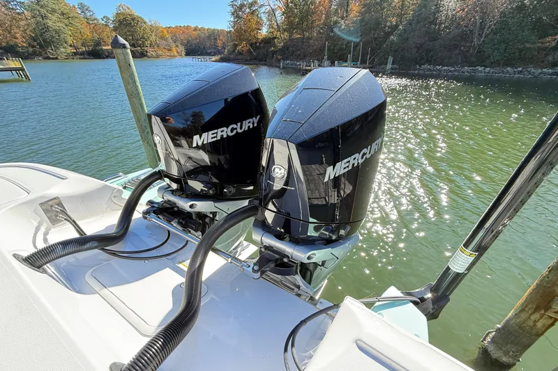  Yacht Photos Pics 2023 Caymas 281 HB boat with dual Mercury outboard engines on a sunny lake.
