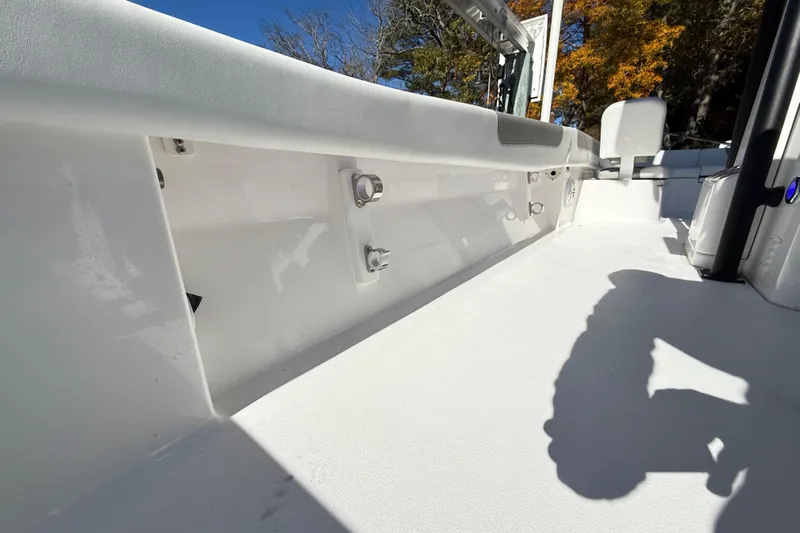  Yacht Photos Pics 2023 Caymas 281 HB boat interior with white deck and seating, under clear blue sky.