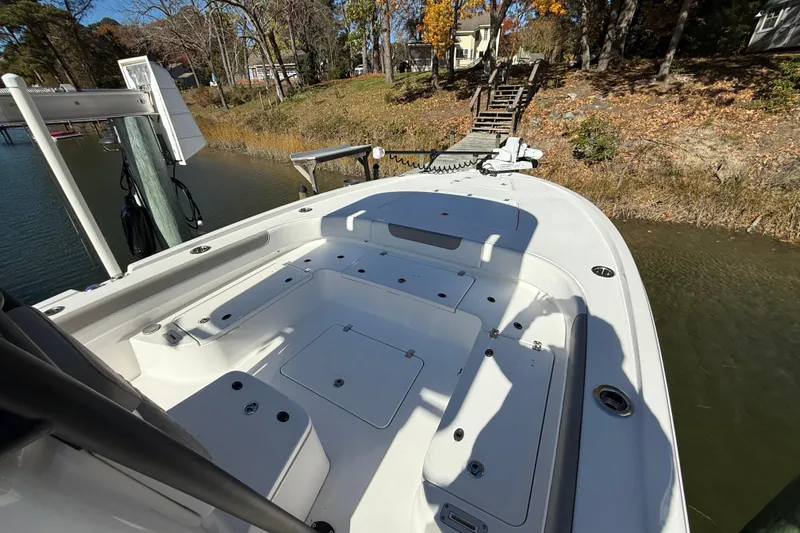  Yacht Photos Pics 2023 Caymas 281 HB boat docked by a wooded shoreline in autumn.