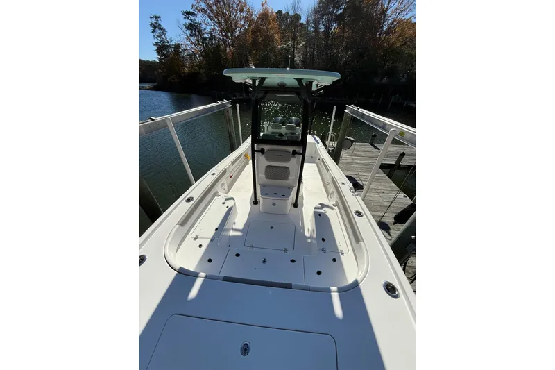  Yacht Photos Pics 2023 Caymas 281 HB boat docked by a serene lake with autumn trees.